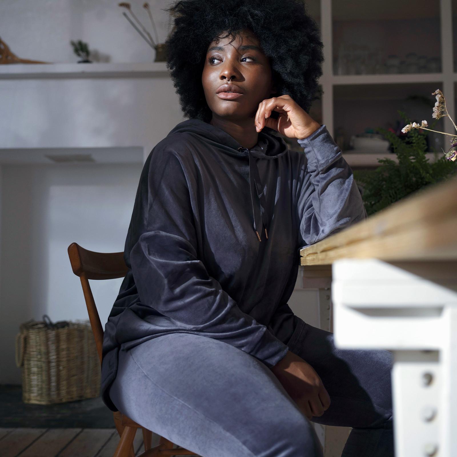 Model wears blue velour tracksuit