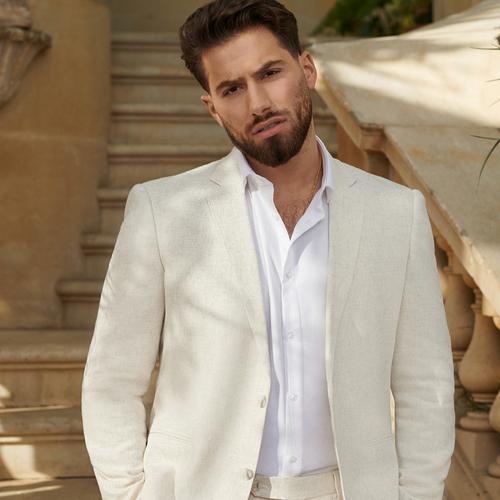 Kem wears ivory linen suit with white shirt