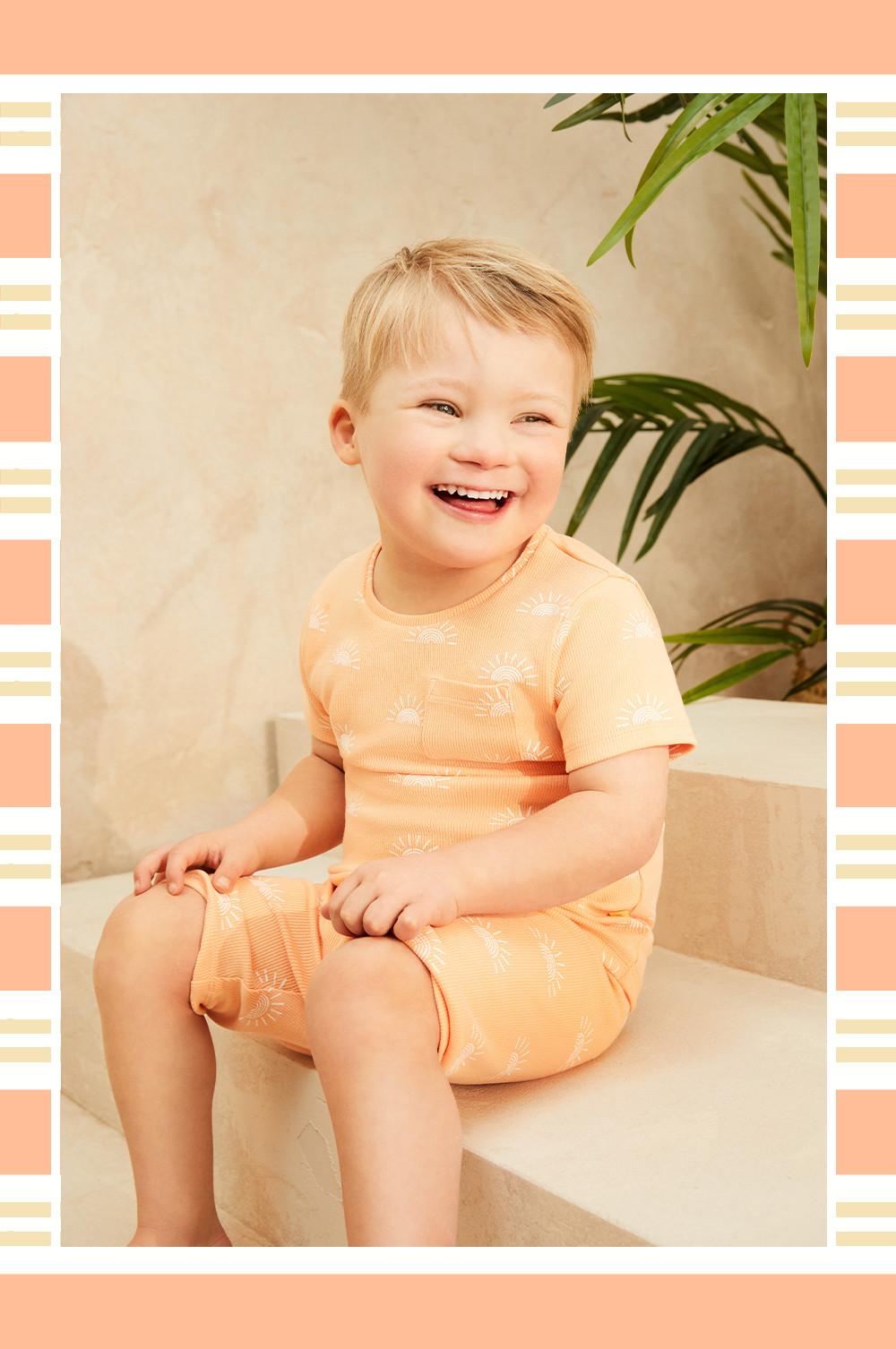 Child wearing orange co-ord