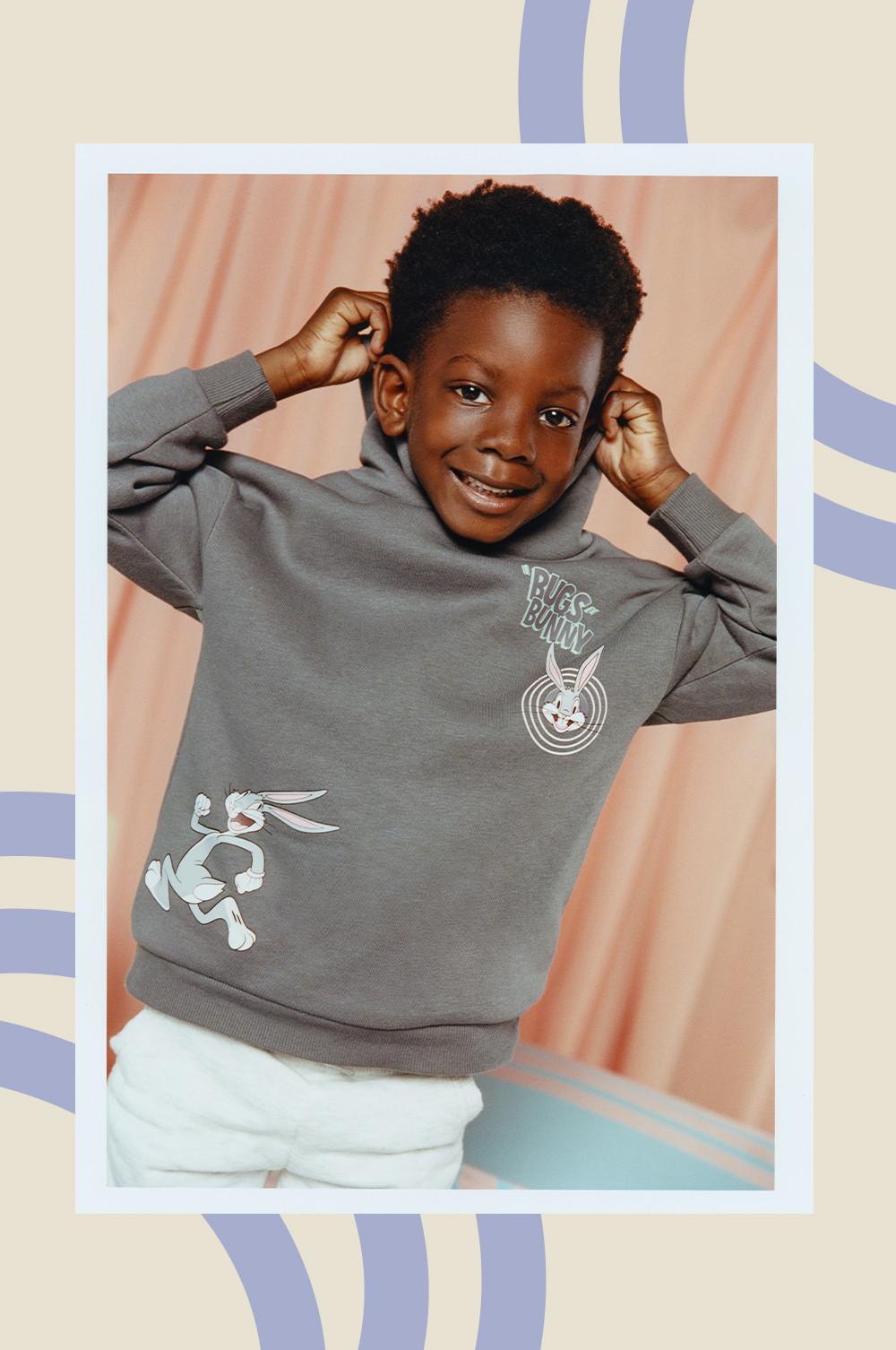 Child in gray Looney Tunes hoodie