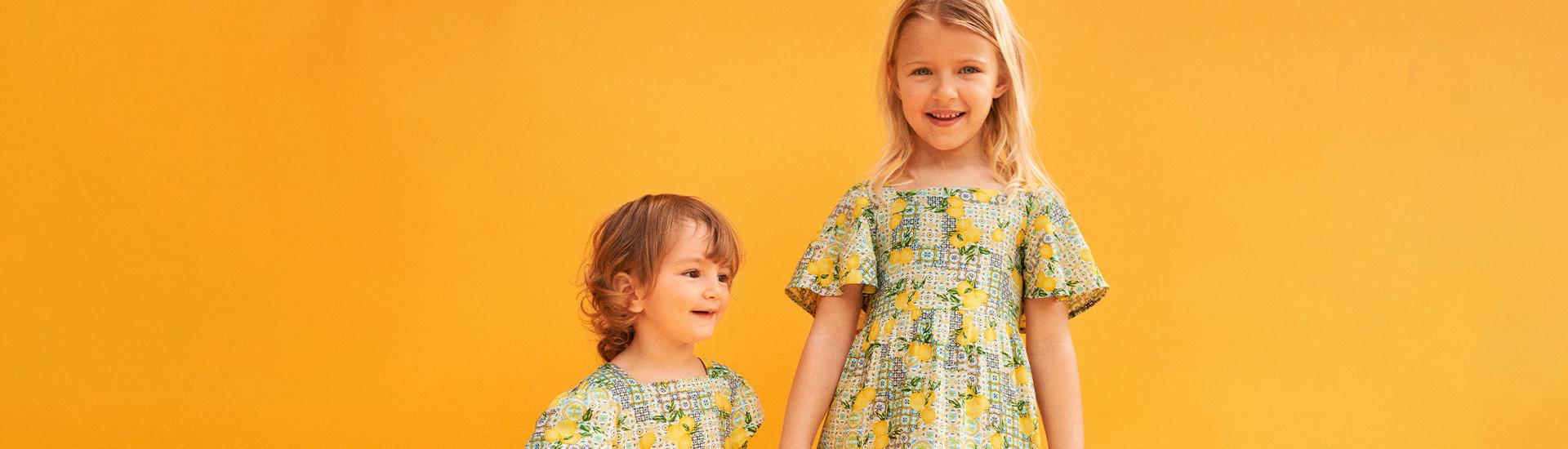 Child wears lemon print midi dress