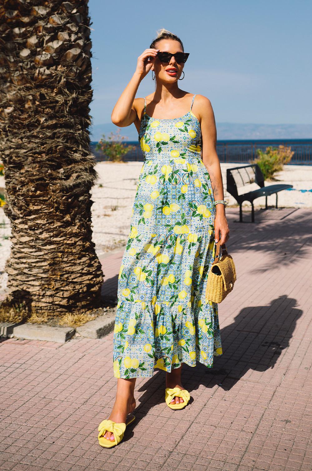 Helen wears lemon print midi dress with yellow shoes and rattan bag