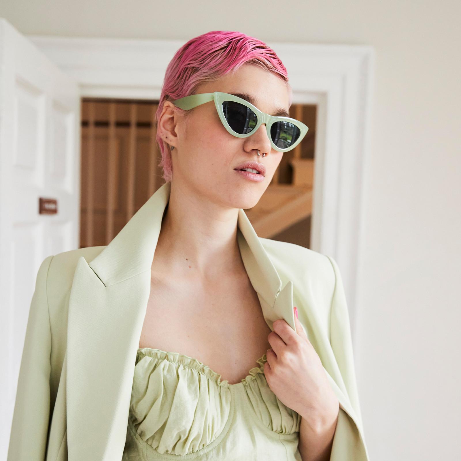 Model wearing green sunglasses