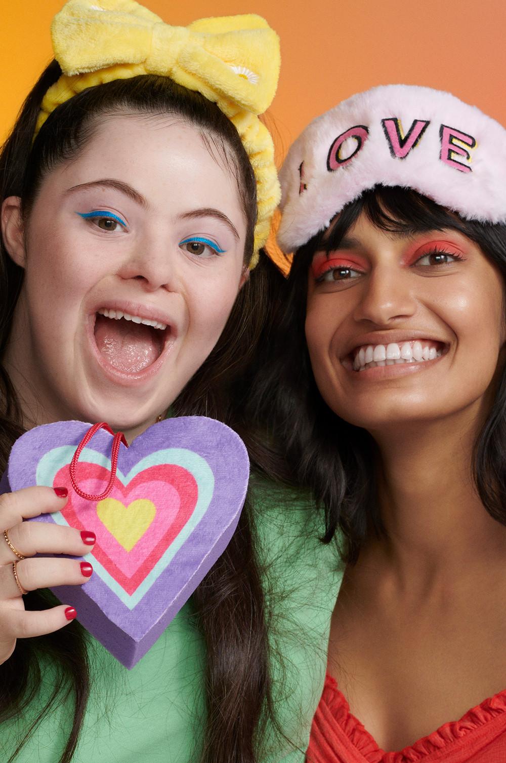 Two models holding heart