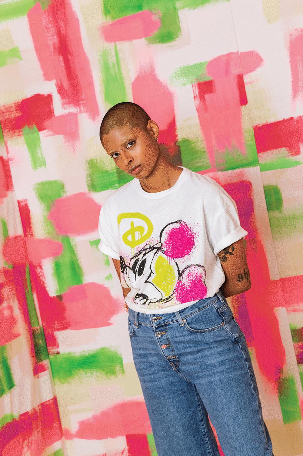 Model wearing White Mickey Mouse Neon Print T-shirt and Jeans