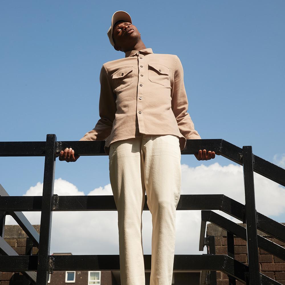 Model wearing light coloured clothing outdoors