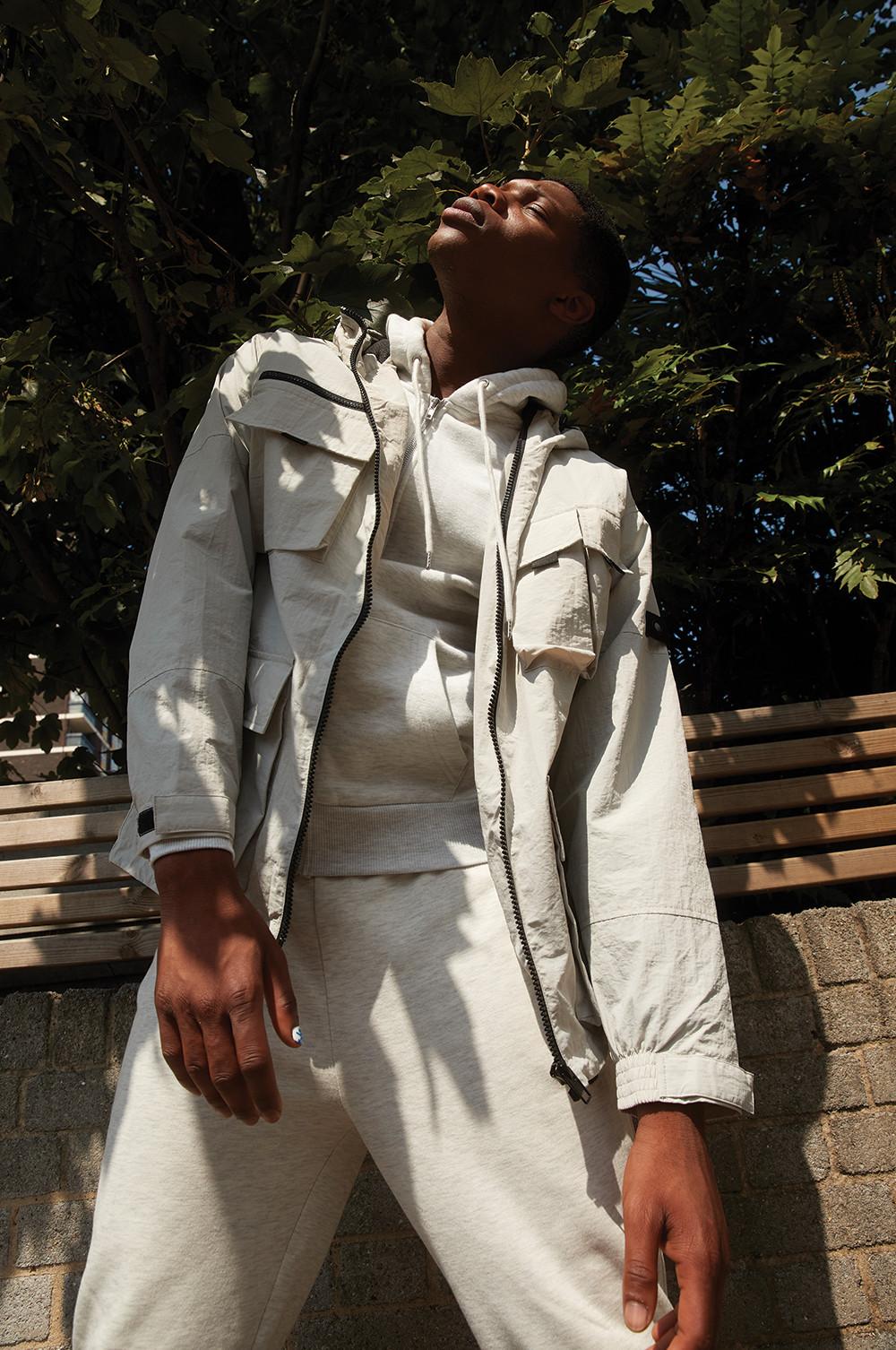 Model wearing light colour jacket and trousers