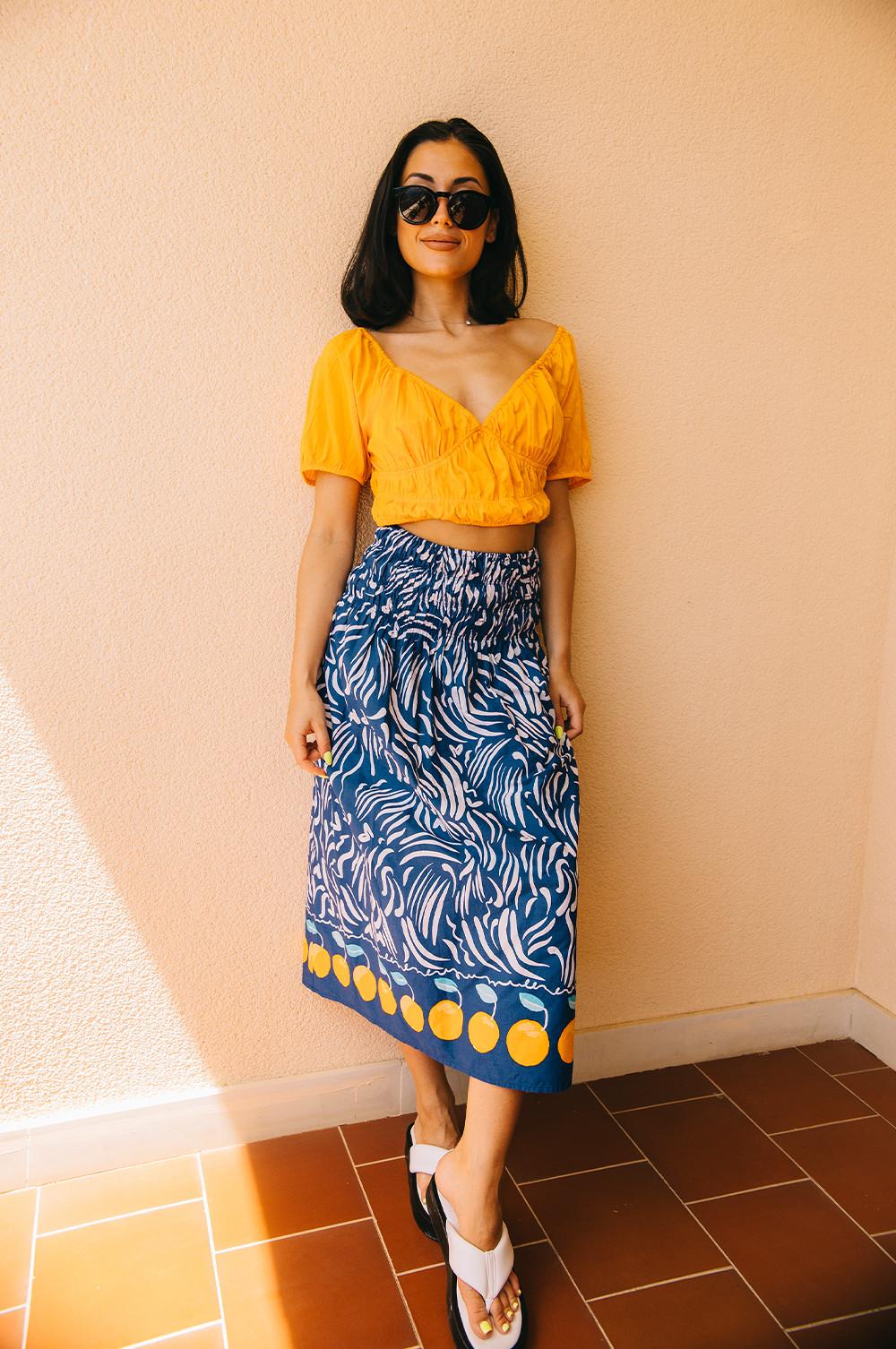 Orange top with blue and white midi skirt with orange detailing