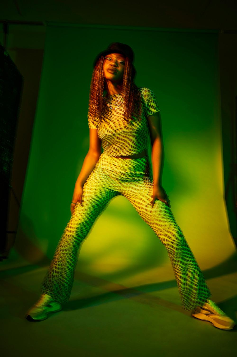 Model wears green mesh two piece with bucket hat