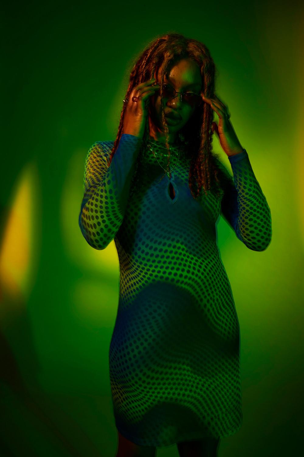 Model wears green printed mesh dress