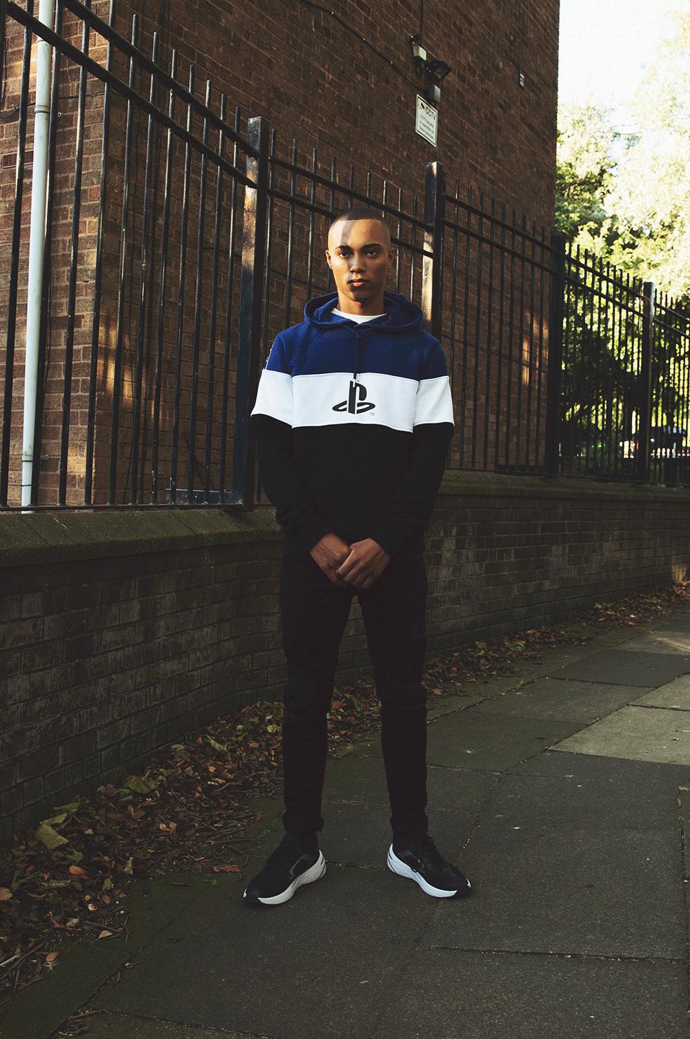 Model wearing playstation colourblock jumper