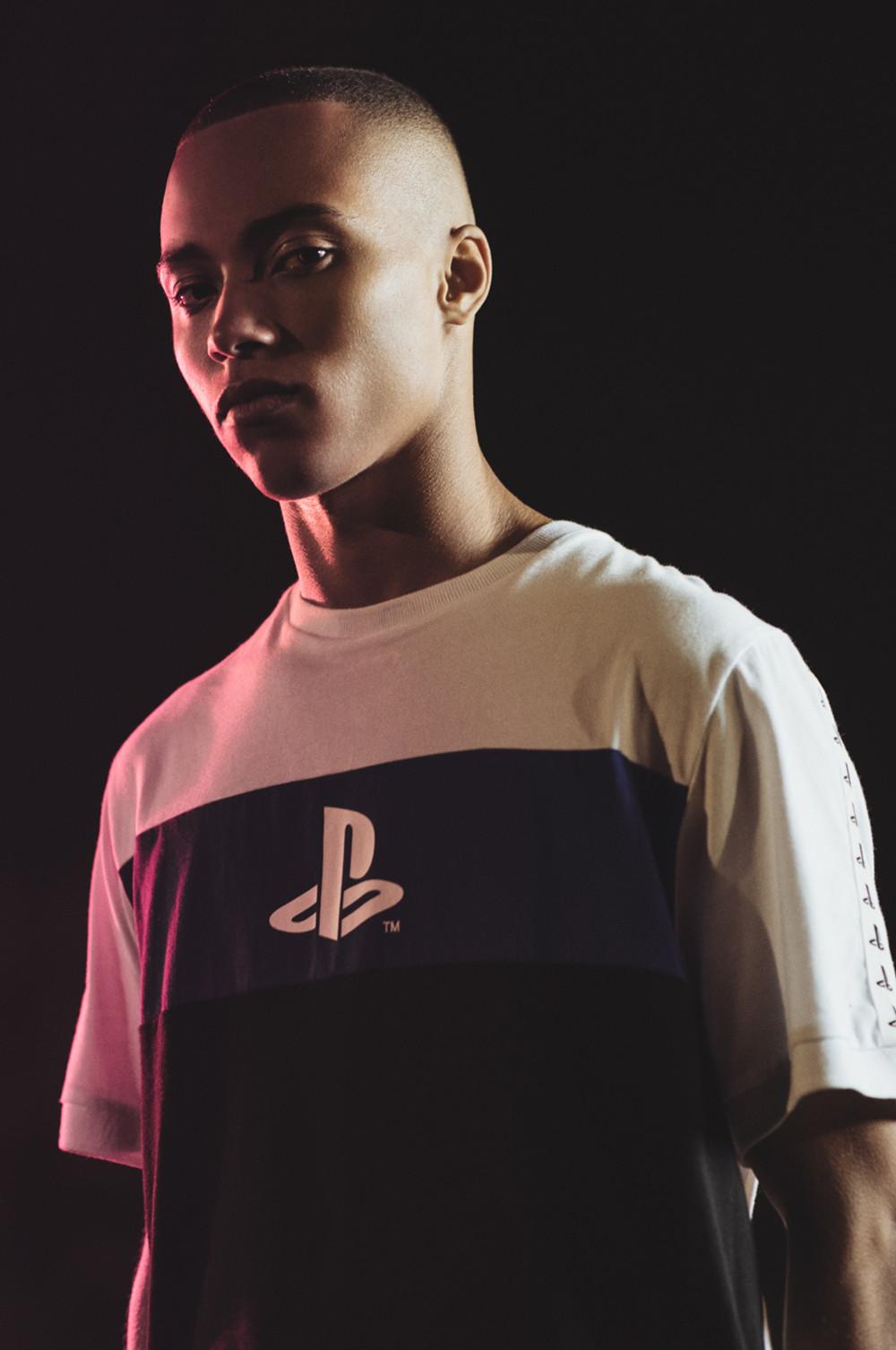 man wearing a primark playstation logo top