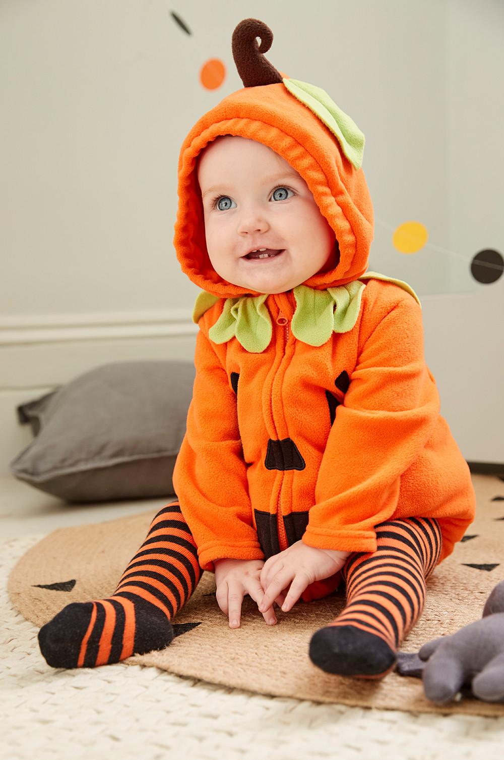 baby in a pumpkin outfit