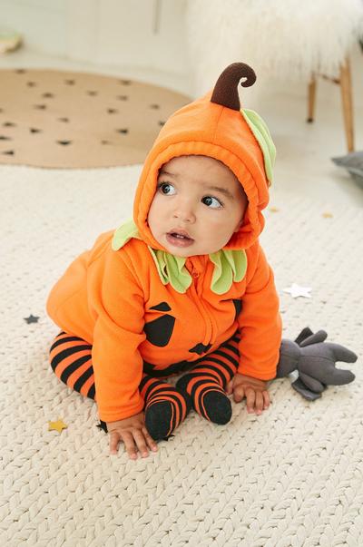 baby in a pumpkin outfit