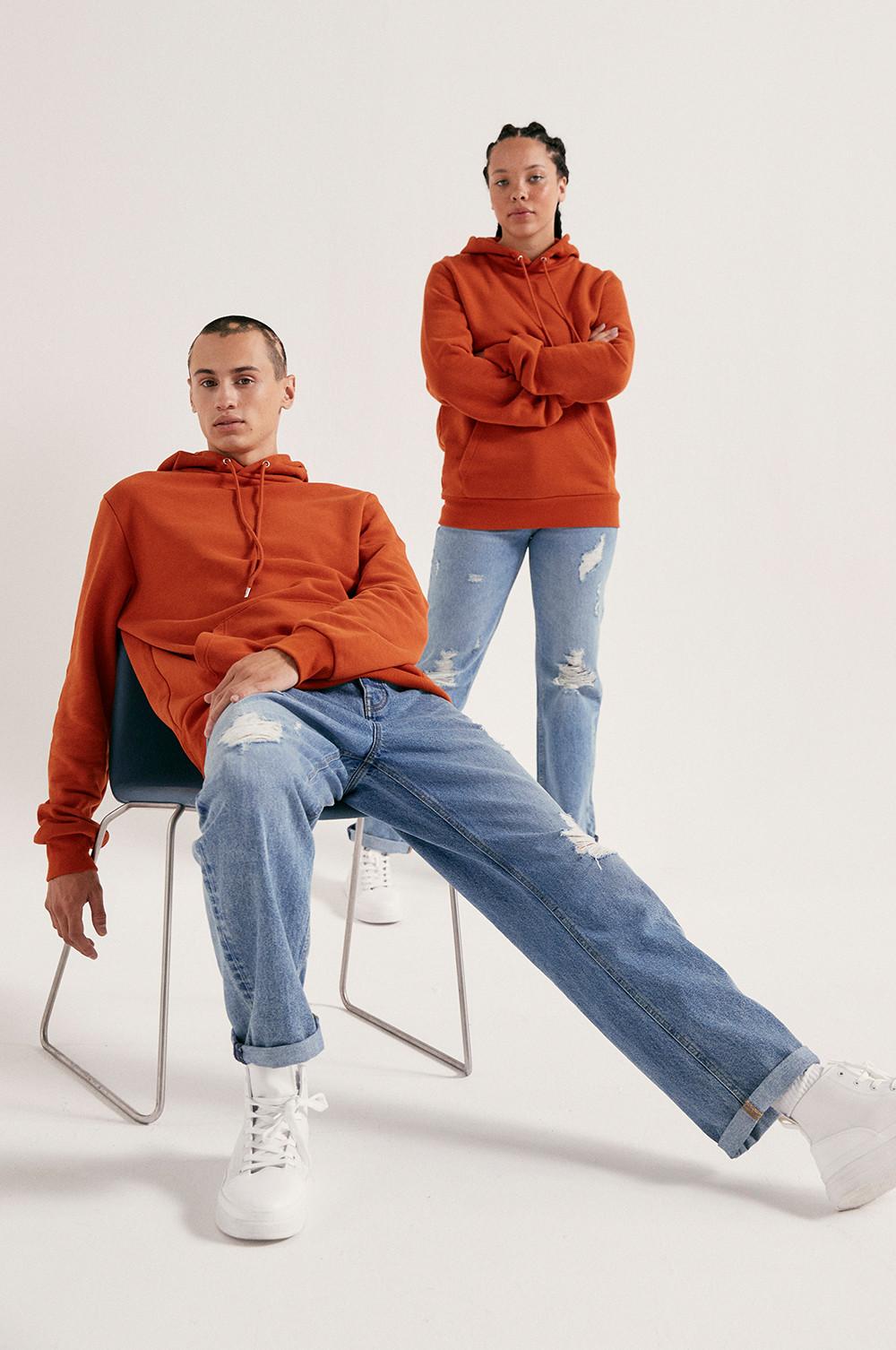 Models wearing Orange Hoodies and Blue Jeans