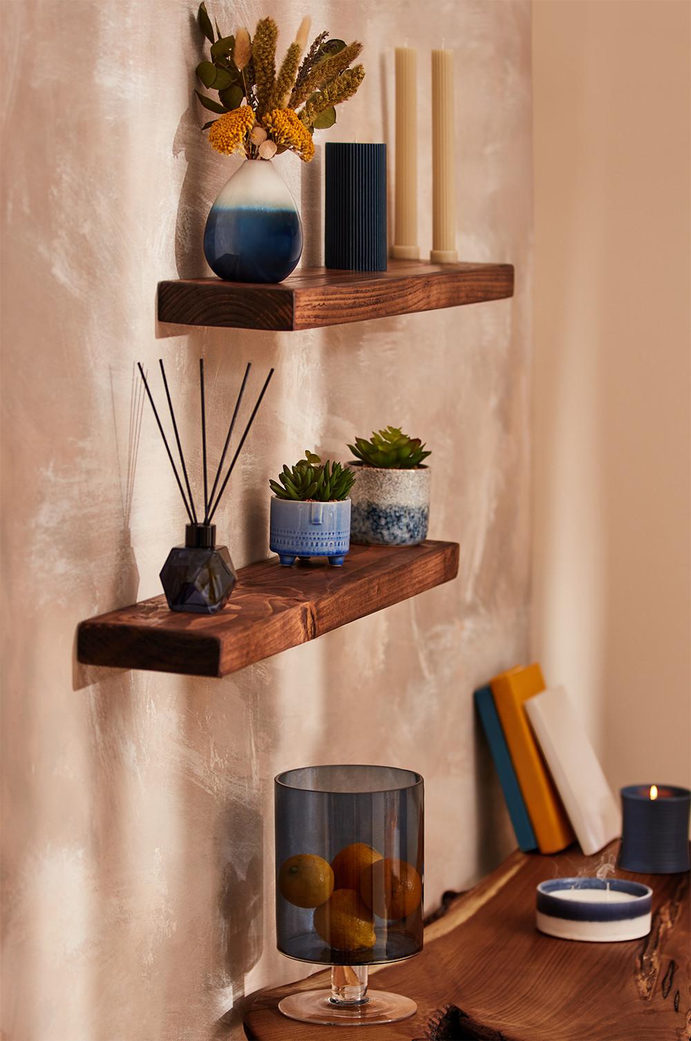 Shelf with a variety of vases, lanterns, candles and more