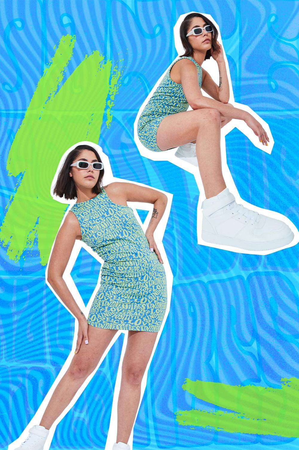 Model wears patterned blue mini dress with white trainers