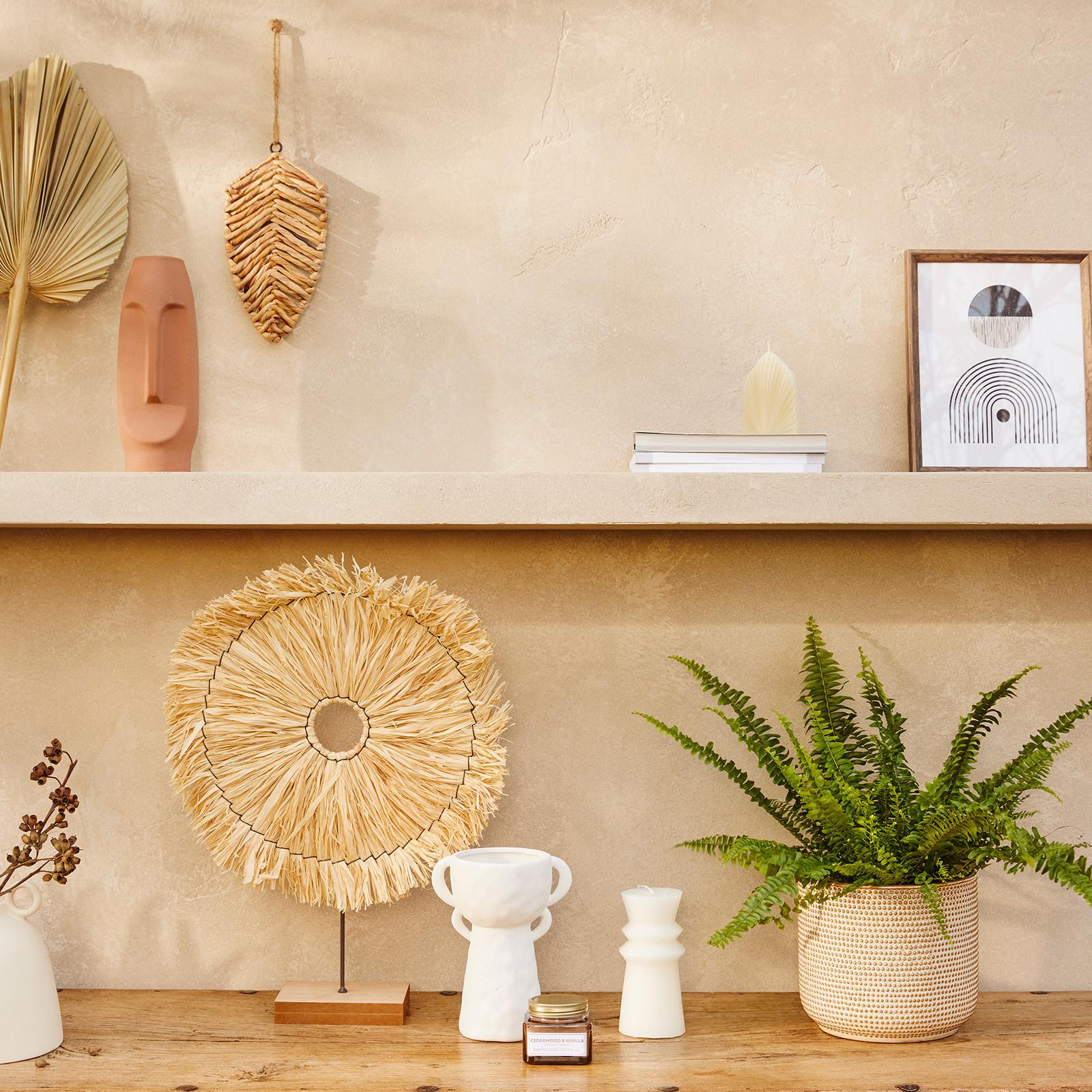 Shelfie set up with faux plants, rustic vases and rattan ornament