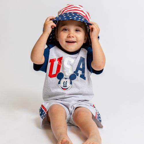 Child wears disney 4th of July collab shorts and tshirt set, with coordinating bucket hat