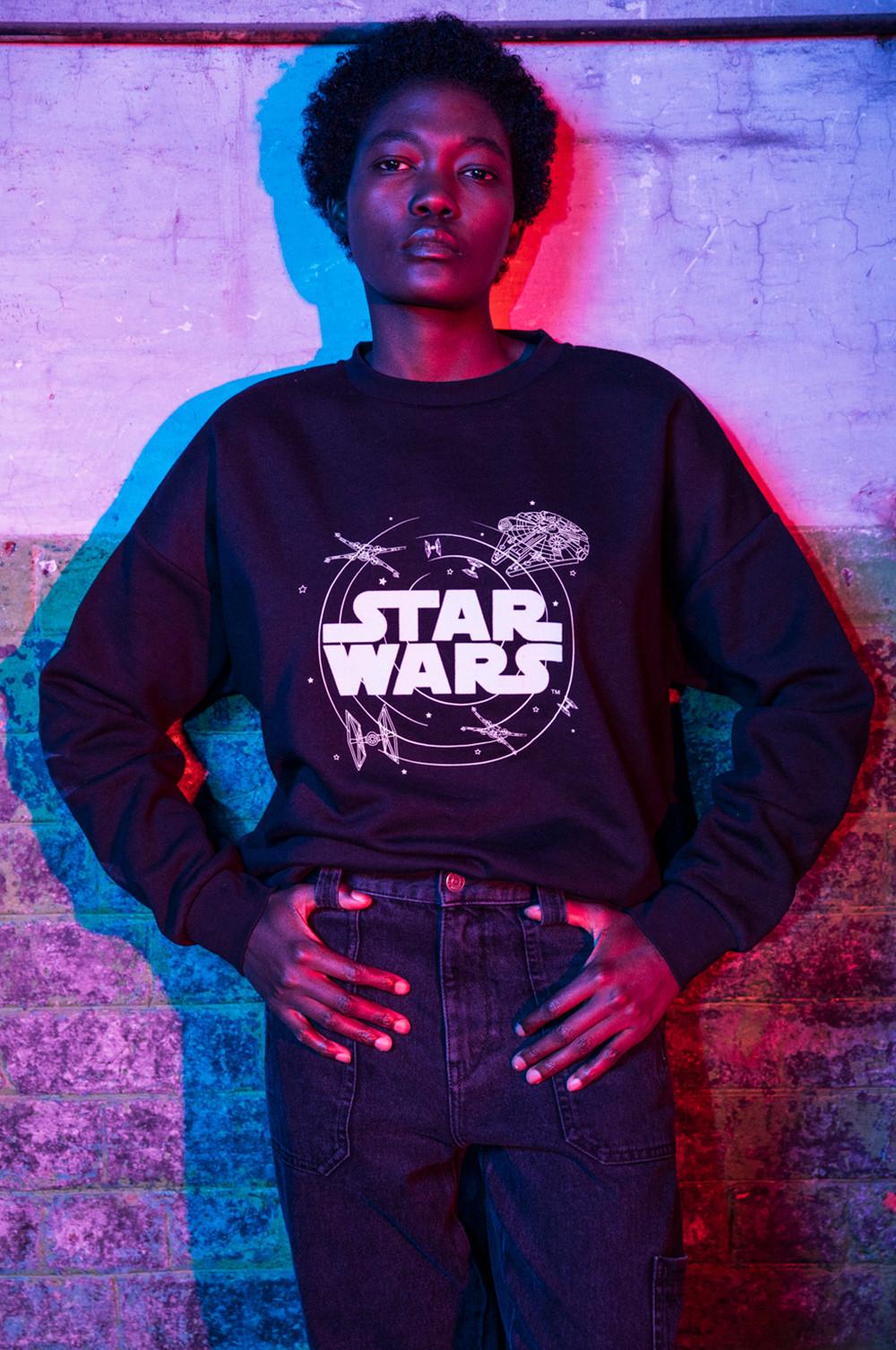 Model in a black Star Wars jumper
