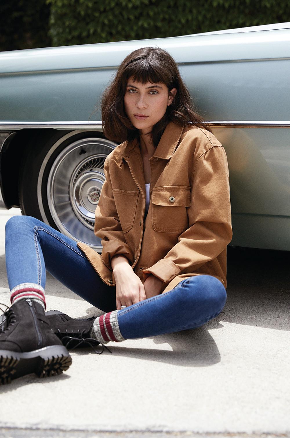 Men's tan leather jacket hanging up