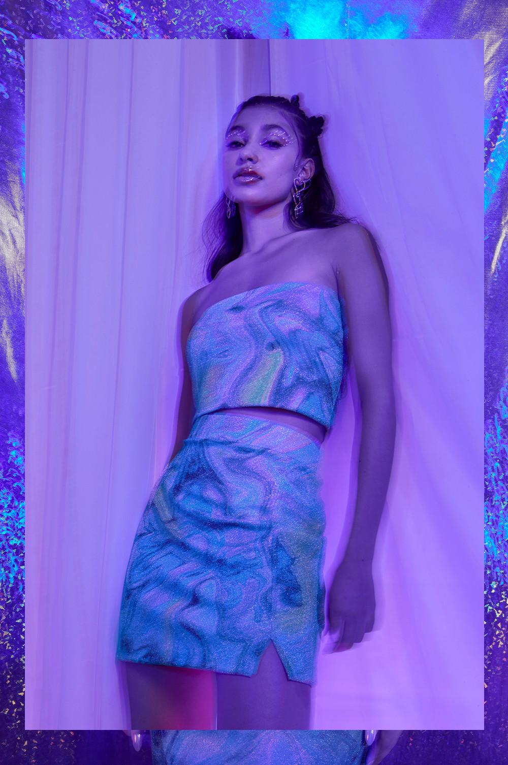 model wears swirl printed coord, with strapless crop top and mini skirt with slit