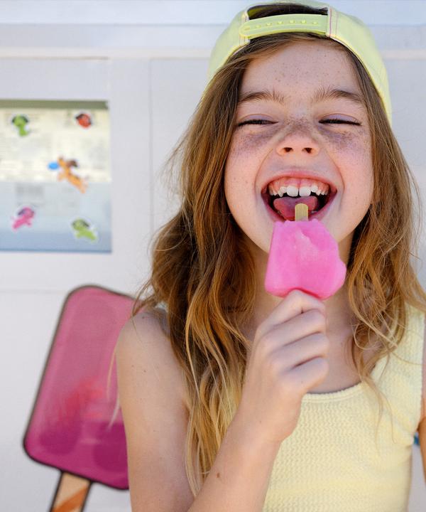 Child smiling with an ice lolly