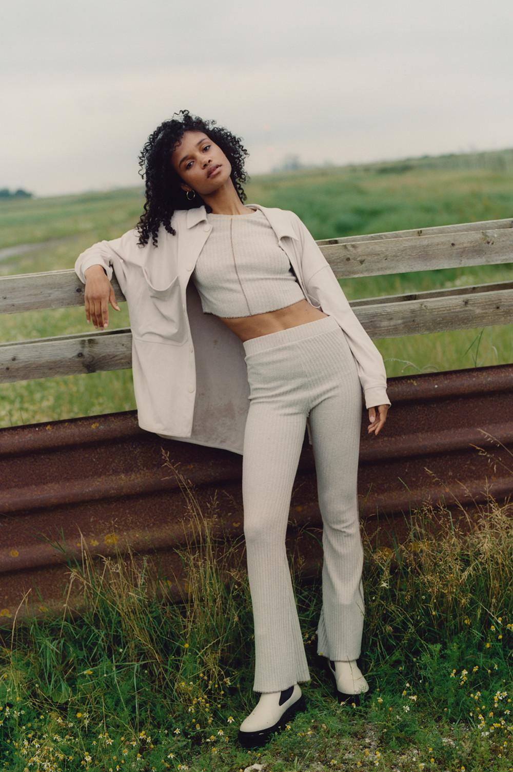 Model wearing beige overshirt, top and trousers