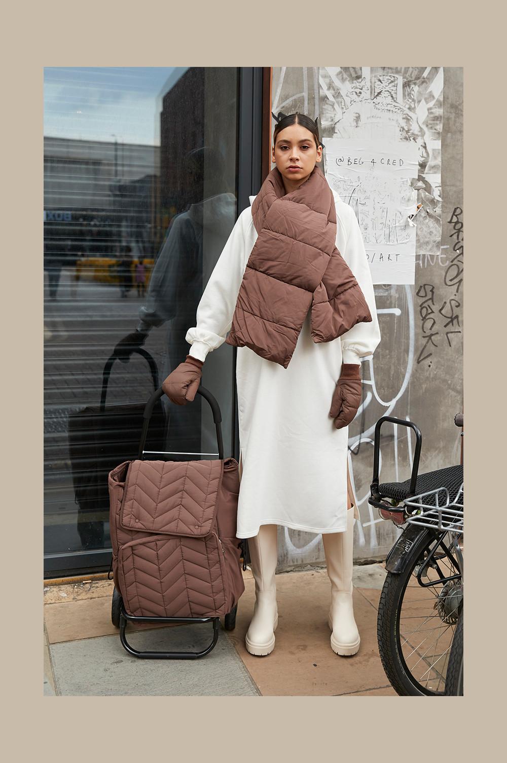 Model wearing quilted scarf and mittens
