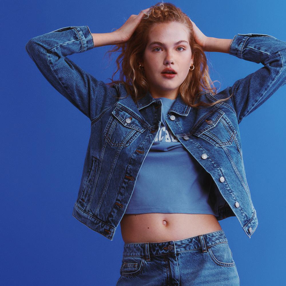 Model wears double denim paired with blue cropped tshirt