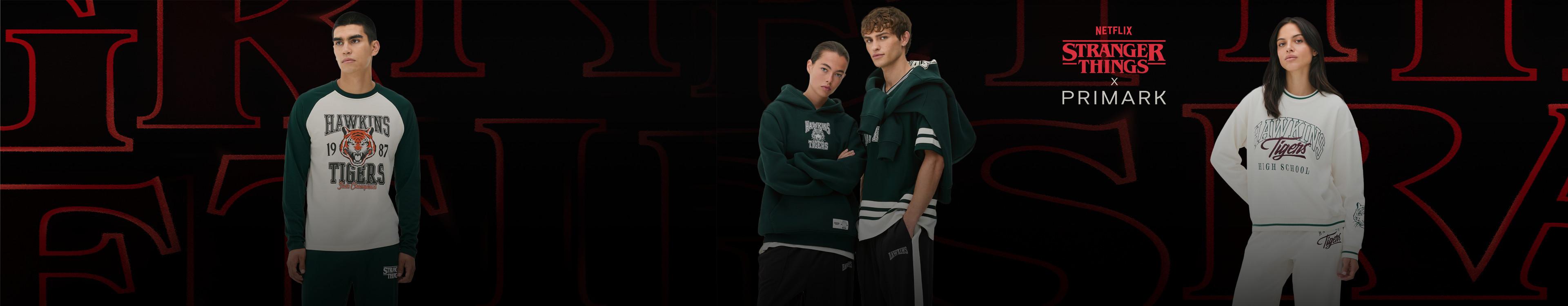 Stranger Things x Primark collection featuring Hawkins Tigers apparel in green and white colours.