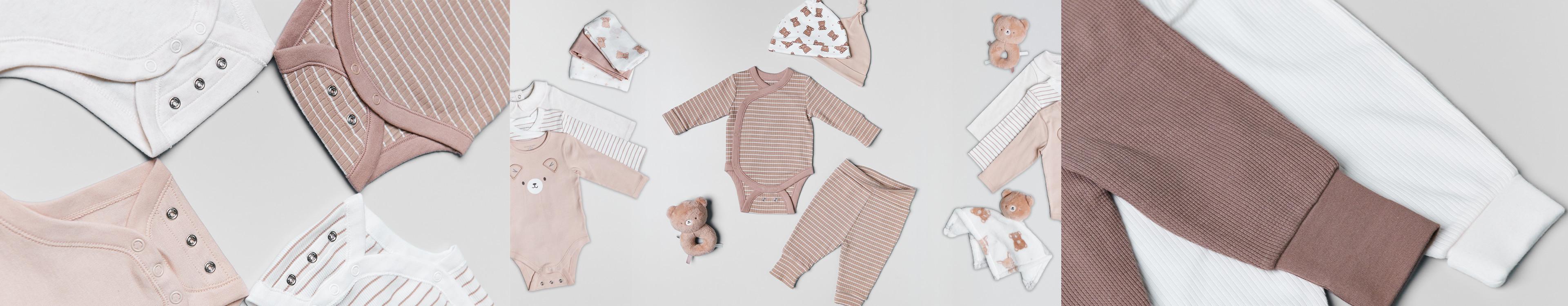 Collection of baby clothes in neutral tones featuring bodysuits, leggings and accessories with teddy bear motifs.