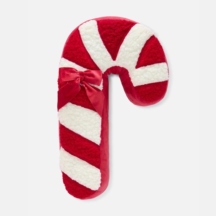 Plush candy cane cushion with red and white stripes and decorative red bow at the curve.