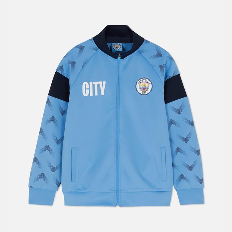 Manchester City football club jacket in light blue with navy collar and geometric pattern on sleeves.