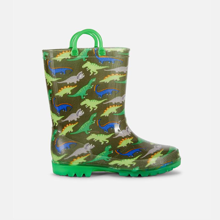 Children's wellington boot with colourful dinosaur pattern on green background and bright green handles.