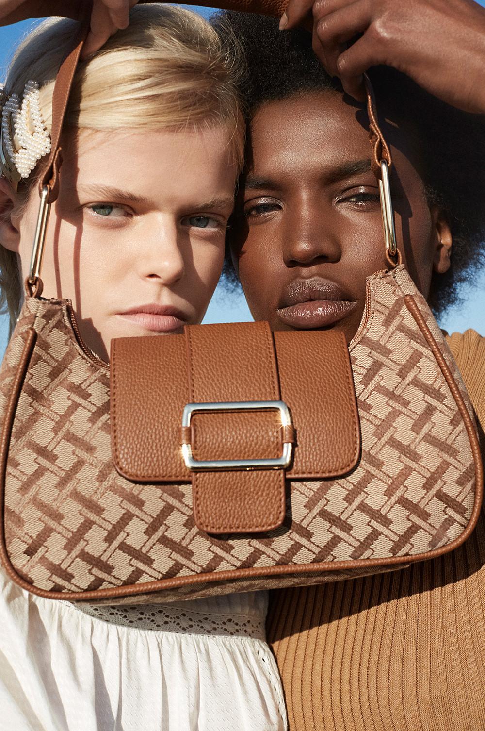 models holding handbag