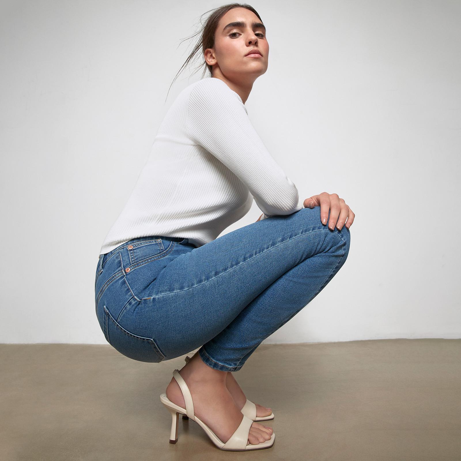model wears skinny blue jeans