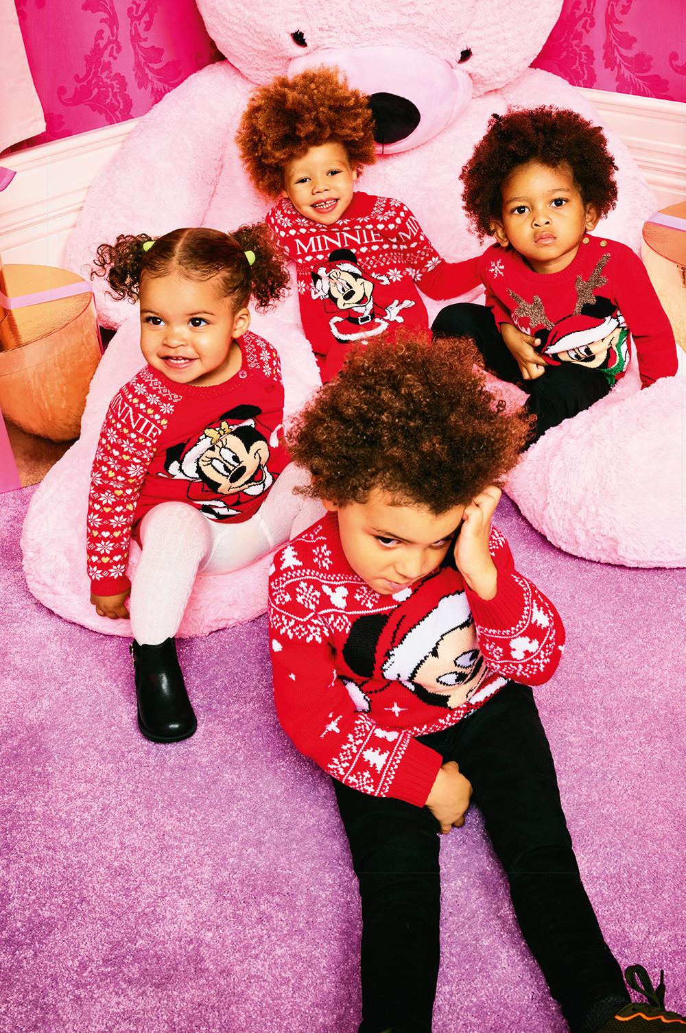Kids in matching red Christmas sweaters