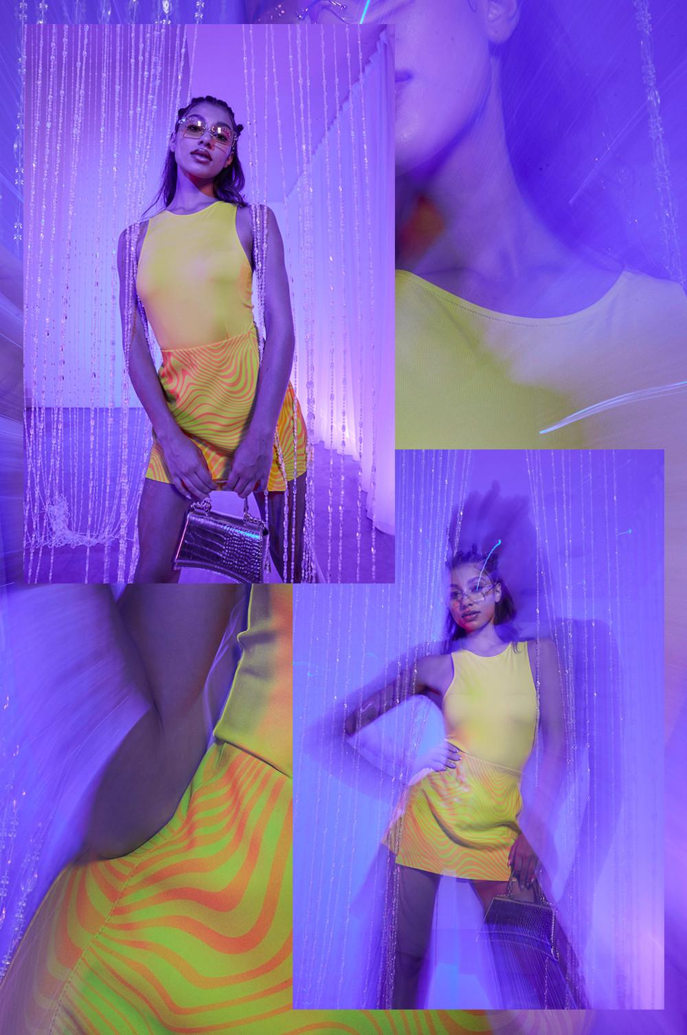 Model in yellow racer bodysuit, printed pink and yellow skirt