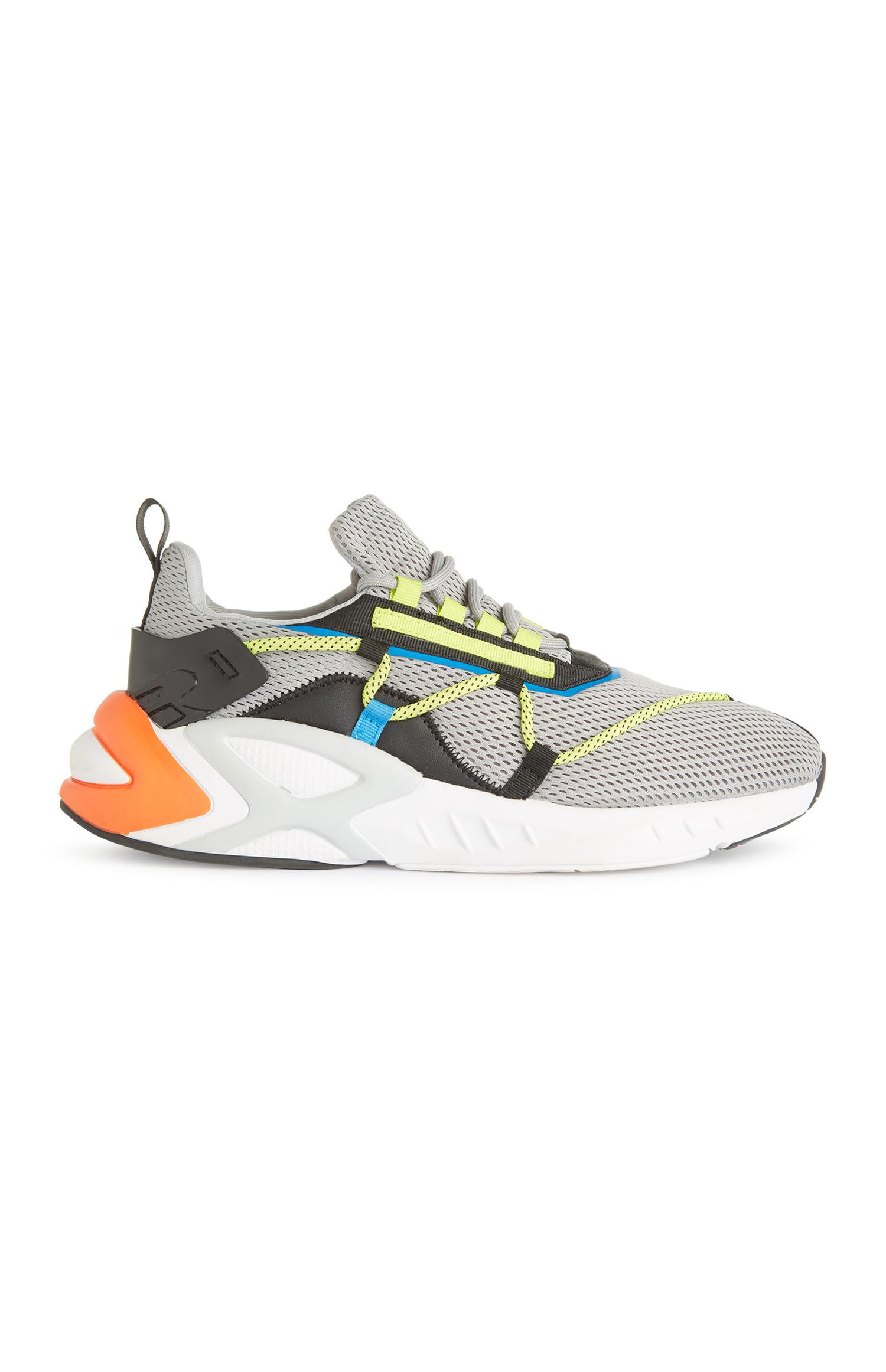 Trainer grigie intessute con dettagli fluo