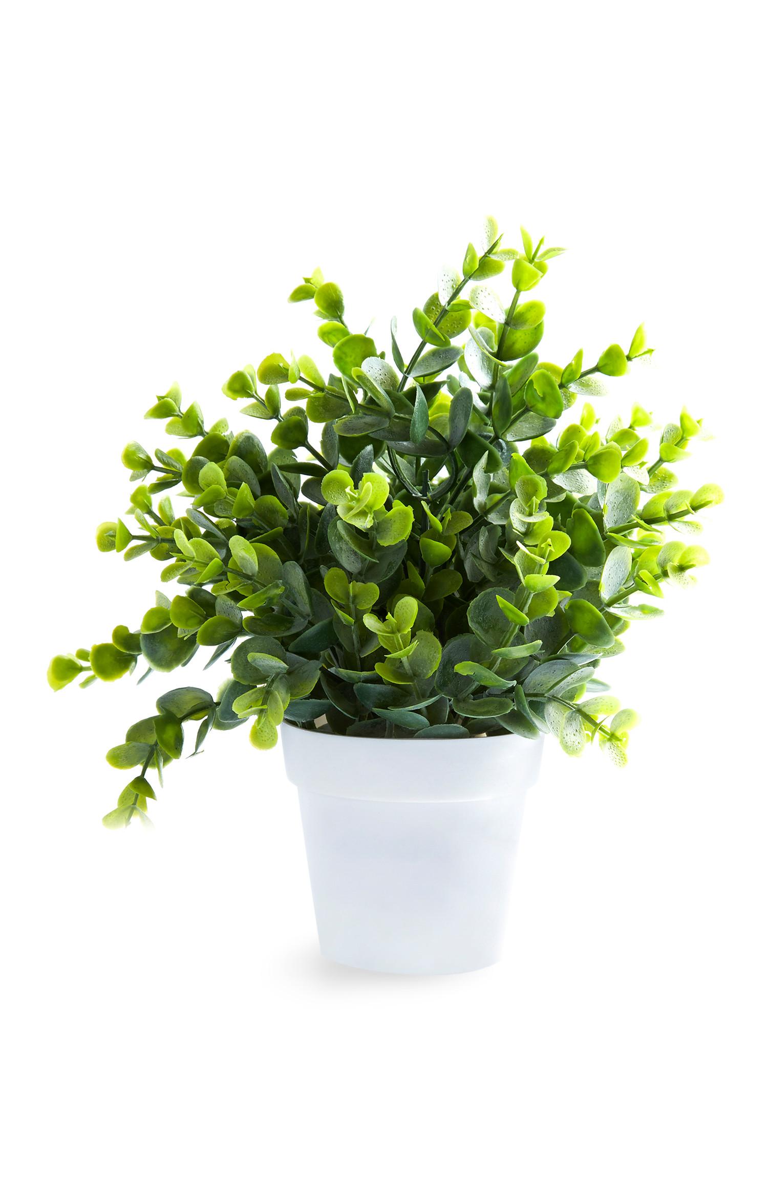 Pianta artificiale con vaso piccolo bianco