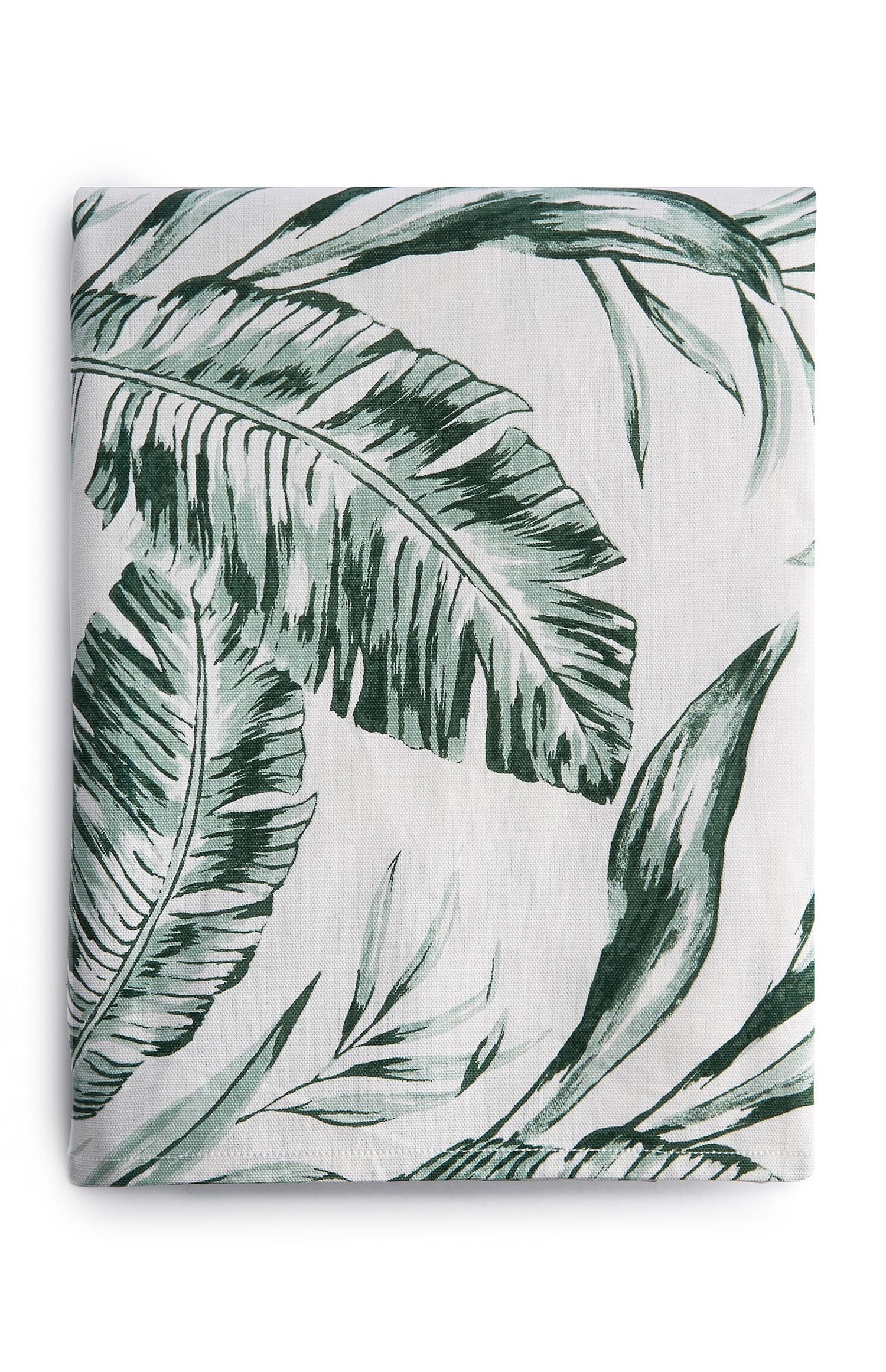 Namizni prt bele barve s potiskom zelenih listov