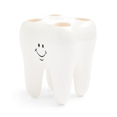 Suport alb în formă de dinte pentru periuță de dinți