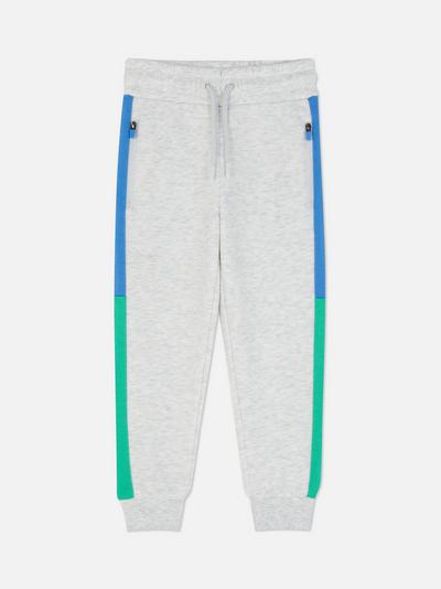 Pantaloni tip jogger cu detalii în două culori